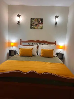 a bedroom with a large bed with two lamps at Quinta dos Viegas in Faro