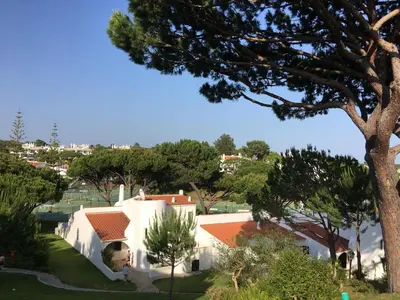 a view of a white house with trees at Vale Do Lobo 935 in Loulé