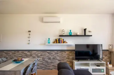 a living room with a table and a tv at Casa Galé - Joia das Sesmarias 600mts praia in Albufeira