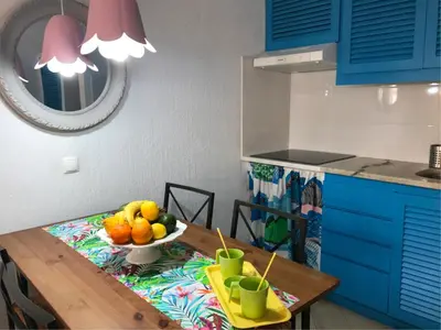 a kitchen with a table with a bowl of fruit on it at Albufeira Jardim 2 Studio in Albufeira