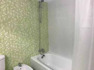 a bathroom with a shower and a tub and a toilet at Albufeira Jardim 2 Studio in Albufeira
