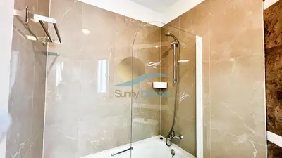 a bathroom with a shower and a bath tub at Villa Golfinho by Sunny Deluxe in Albufeira
