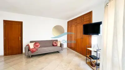 a living room with a couch and a flat screen tv at Villa Golfinho by Sunny Deluxe in Albufeira