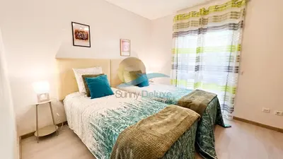 a small bedroom with a bed and a window at Villa Golfinho by Sunny Deluxe in Albufeira