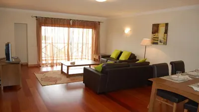 a living room with a couch and a table at Apartamento Corcovada - By Bedzy in Albufeira
