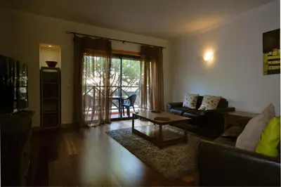 a living room with a couch and a coffee table at Apartamento Corcovada - By Bedzy in Albufeira