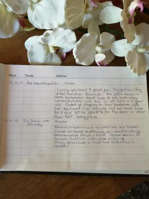a piece of paper with white flowers on a table at Apartamento Corcovada - By Bedzy in Albufeira