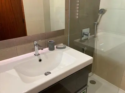 a bathroom with a sink and a shower at Urbisol 202-Albufeira in Albufeira