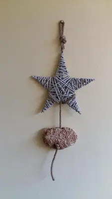 a starfish hanging on a wall next to a rock at Olhos Do Mar Albufeira in Albufeira