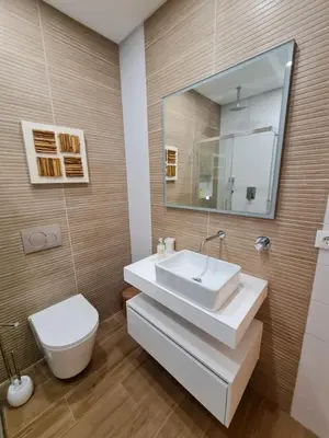 a bathroom with a sink and a toilet and a mirror at Victoria Studio in Vilamoura