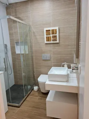 a bathroom with a shower and a toilet and a sink at Victoria Studio in Vilamoura
