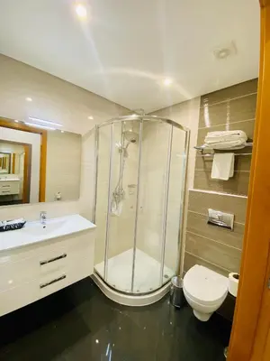a bathroom with a shower and a toilet and a sink at Sunfield Guest House - Only Adults in Albufeira