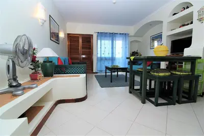 a kitchen and living room with a table with a fan at Belavista Centre - Albufeira in Albufeira