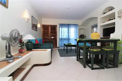 a living room with a kitchen and a table at Belavista Centre - Albufeira in Albufeira