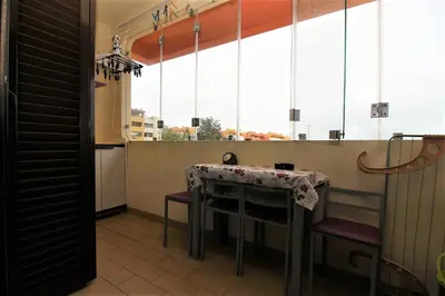 a kitchen with a table and some windows at Belavista Centre - Albufeira in Albufeira