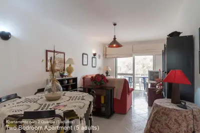 a living room with a table and a couch at Akisol Vilamoura Pine in Quarteira