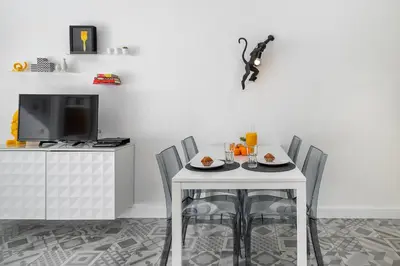 a dining room with a white table and chairs at Warm Yellow Albufeira in Albufeira