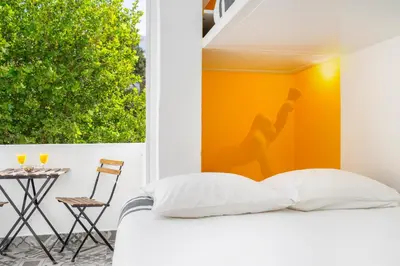 a bedroom with a bed and a table and a chair at Warm Yellow Albufeira in Albufeira