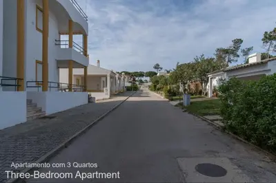 an empty street next to a three bedroom apartment at Akisol Albufeira Falesia IV in Albufeira