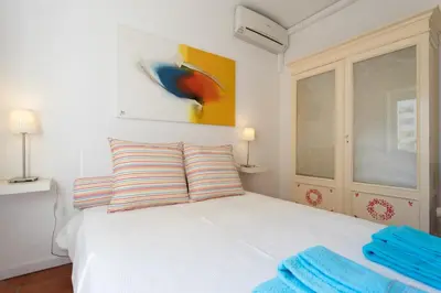 a bedroom with a white bed with two pillows at FLH Vilamoura Central Flat in Quarteira
