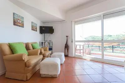 a living room with a couch and a tv at FLH Vilamoura Central Flat in Quarteira