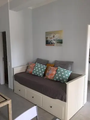 a bed with pillows on it in a room at Fully Renovated Studio in Albufeira