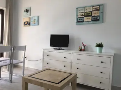 a white dresser with a television on top of it at Fully Renovated Studio in Albufeira
