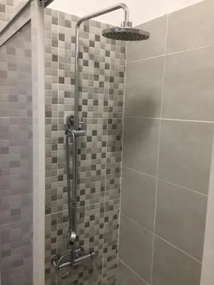 a shower with a shower head in a bathroom at Fully Renovated Studio in Albufeira