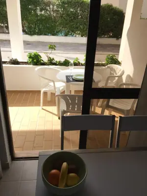 a bowl of fruit sitting on a table in front of a balcony at Fully Renovated Studio in Albufeira