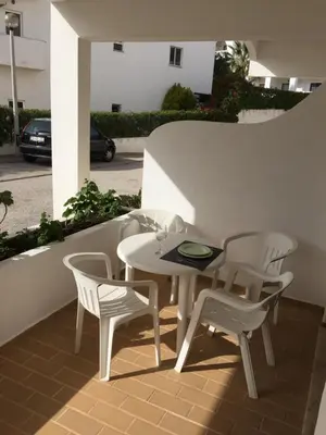 a white table and chairs on a patio at Fully Renovated Studio in Albufeira