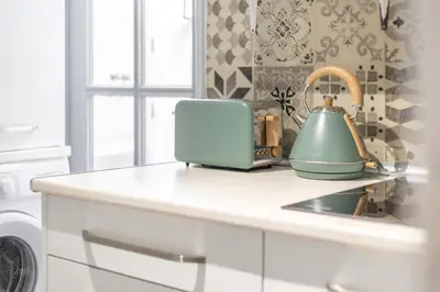 a kitchen counter with a toaster and a tea kettle at The Central Townhouse in Faro