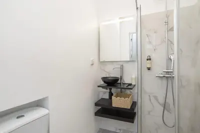 a bathroom with a sink and a shower at The Central Townhouse in Faro