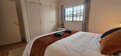a living room with a bed and a table and chairs at Fisherman's Townhouse at Old Town in Albufeira