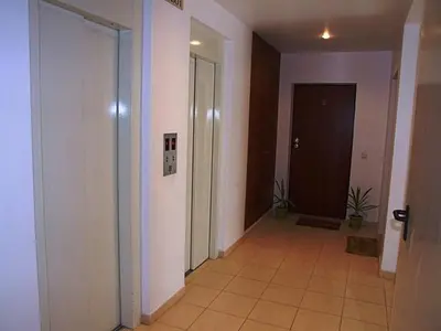 an empty hallway with a door and a tile floor at Apartment Salgados T1 in Guia