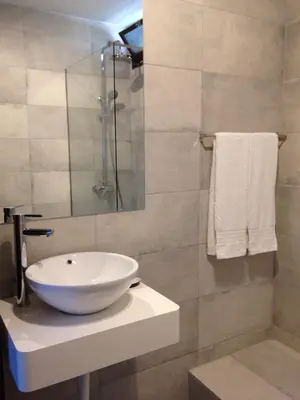 a bathroom with a white sink and a shower at Casa Balaia in Albufeira