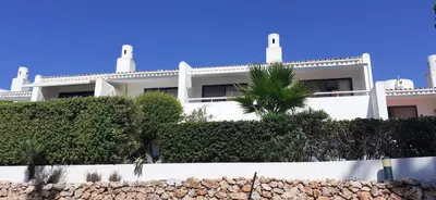 a white living room with a white couch and a table at Quinta do Lago Beach House in Quinta do Lago