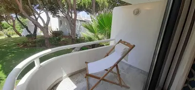 a bedroom with a white bed and a large window at Quinta do Lago Beach House in Quinta do Lago
