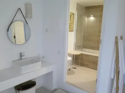 a white bathroom with a sink and a mirror at T4 Grand Townhouse Old Village in Vilamoura