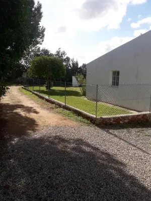 a chain link fence in front of a building at casa de ferias in Algoz