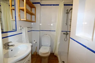 a bathroom with a toilet and a sink and a shower at Marbel Sol - Clever Details in Vilamoura