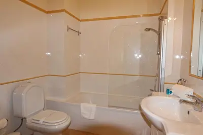 a bathroom with a toilet and a sink and a tub at Marbel Sol - Clever Details in Vilamoura