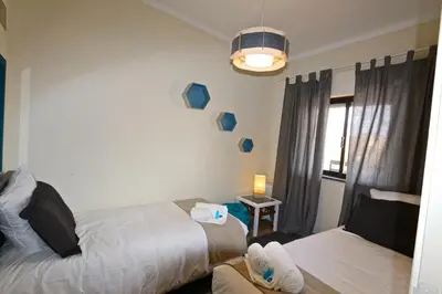 a hotel room with two beds and a window at Marbel Sol - Clever Details in Vilamoura