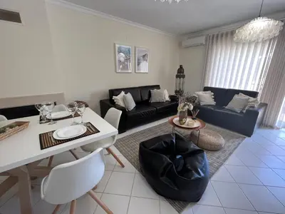 a living room with a couch and a table at Condominio Cerro da Guia in Guia