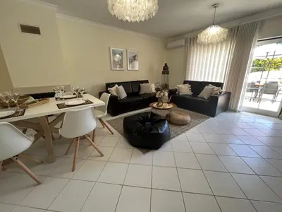 a living room with a couch and a table at Condominio Cerro da Guia in Guia
