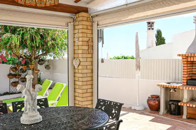 a patio with a table with a cat statue on it at Villa Tibouchina in Albufeira