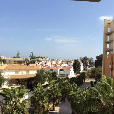 a view of a city with palm trees and buildings at Apartamento Vilamoura in Quarteira