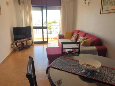 a living room with a couch and a table at Apartment on The Strip Albufeira in Albufeira