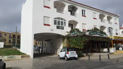 a small car parked in front of a building at Apartment on The Strip Albufeira in Albufeira