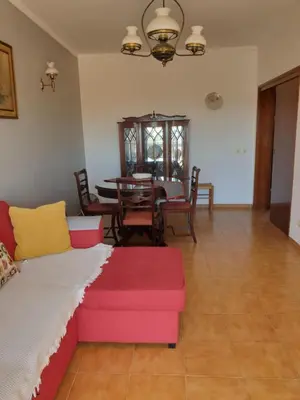 a living room with a couch and a table at Apartment on The Strip Albufeira in Albufeira