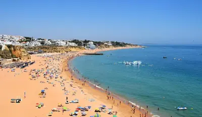 a group of people on a beach in the water at Apartamento Bela Vista in Albufeira